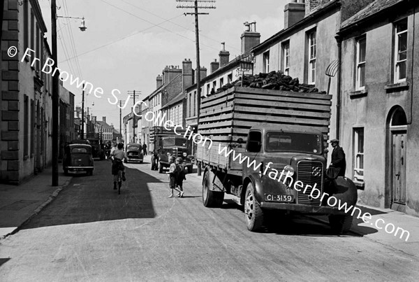 NARROW STREET WITH TURF LORRY